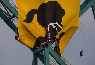 Activists install a banner on a piling barge of the coal-fired power plant project off the shores of Batang, Central Java, on Thursday (30/03). (Greenpeace Photo/Ulet Ifansasti)