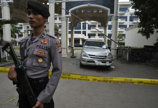 A policeman stands guard in front of the empty Mandalika Hotel in Serang, Banten, after what the police claim to be the 'largest ever' crystal meth seizure inside the hotel. (Antara Photo/Asep Fathulrahman)