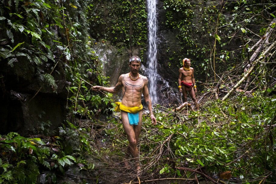 Rob Henry, Australian surfer and filmmaker, pictured in the jungle regions of Siberut Island in Mentawai with Sikerei Masit Dere. (Photo courtesy of Chris Hopkins)