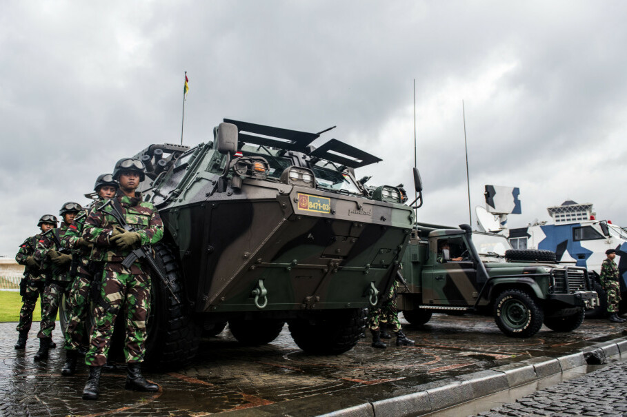 Indonesian soldiers flank an Anoa armored personnel carrier developed by state-owned arms manufacturer Pindad. (Antara Photo/M Agung Rajasa)