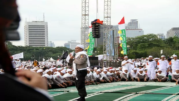 Aksi polisi yang mengenakan peci putih dan sorban mampu menyedot perhatian puluhan ribu umat Islam yang memadati kawasan Monas, Jakarta, Jumat, 2 Desember 2016..