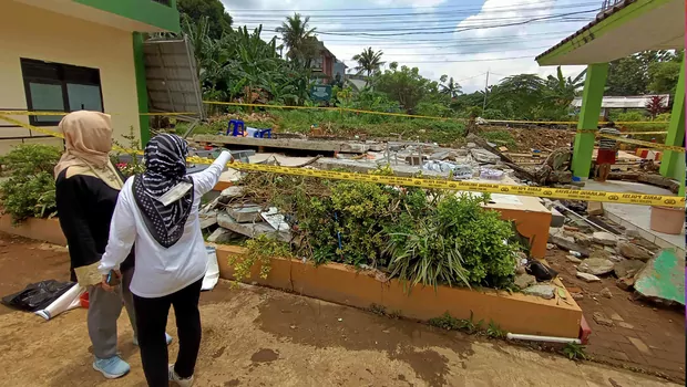 Orang tua siswa melihat reruntuhan tembok yang roboh akibat banjir dan menewaskan tiga siswa di MTsN 19 Cilandak, di Jakarta, Jumat, 7 Oktober 2022.