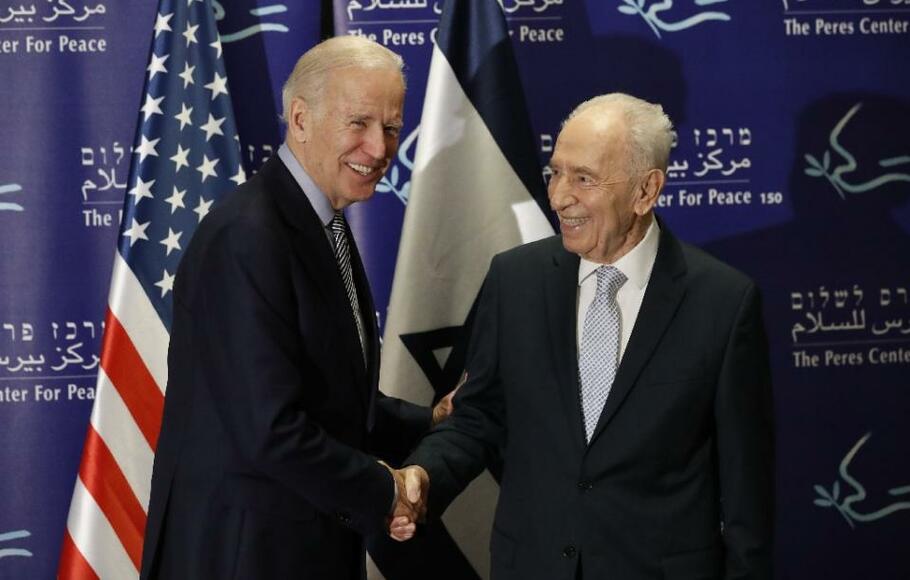 Wakil Presiden Amerika Serikat (AS) Joe Biden (kiri) berjabat tangan dengan mantan Presiden Israel Shimon Peres dalam rapat yang diselenggarakan d Tel Aviv, pada Selasa, 8 Maret 2016.