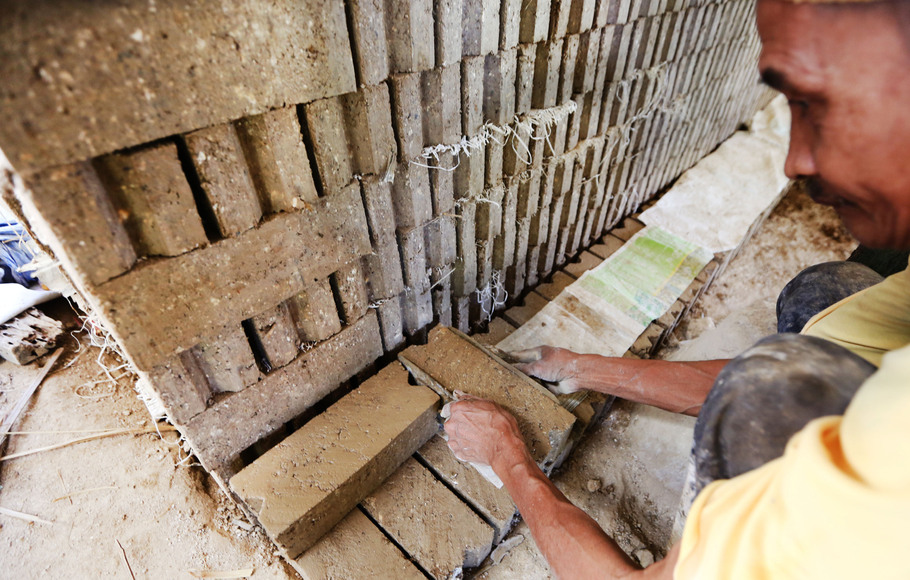 Pekerja sedang menyelesaikan pembuatan batako di Ciampea, Bogor, Selasa (13/7/2021).