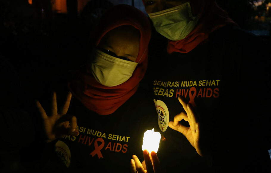 Sejumlah relawan dan aktivis kesehatan menyalakan lampu dalam malam renungan Hari AIDS Sedunia di Tanah Abang, Jakarta, Rabu 1 Desember 2021. 
