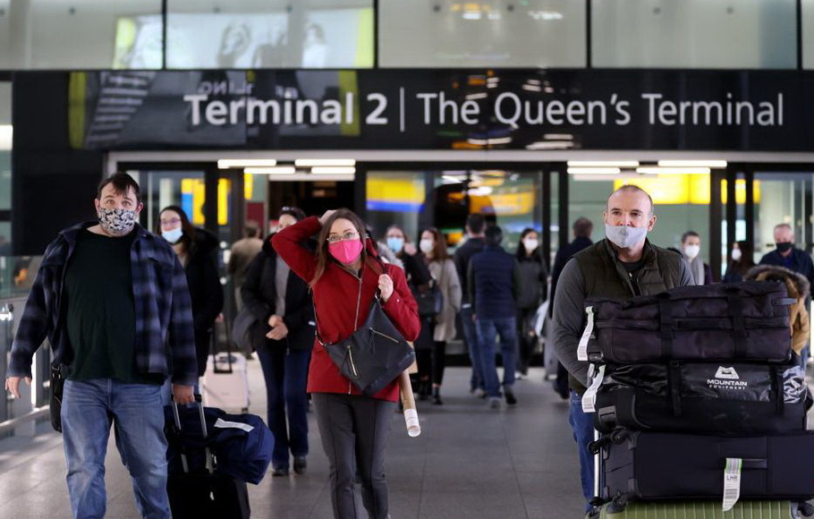 Para penumpang berjalan di Bandara Heathrow di London, Inggris, Selasa 30 November 2021.