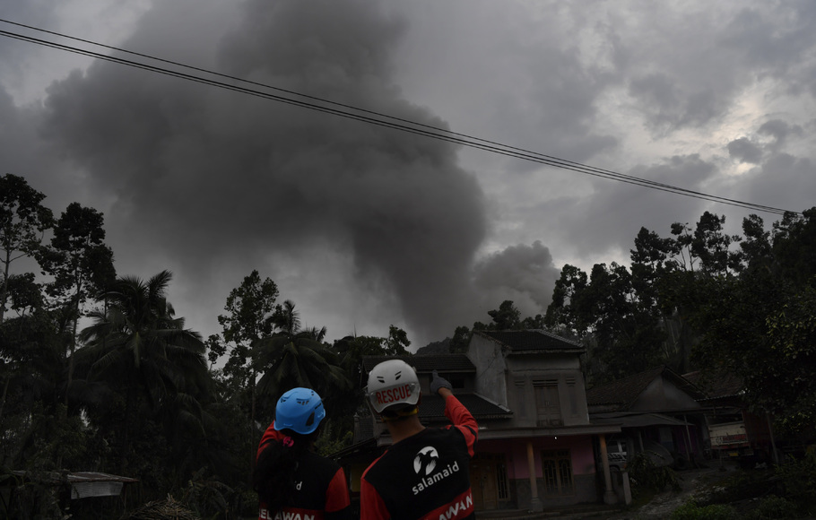 Relawan mengamati guguran awan panas Gunung Semeru di Desa Sumber Wuluh, Lumajang, Jawa Timur, Minggu 5 Desember 2021. 