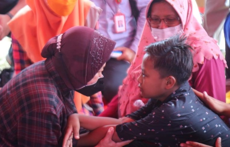 Mensos Tri Rismaharini menghibur anak-anak pengungsi Semeru di tenda pengungsian di Lapangan Tirtosari, Desa Penanggal, Kabupaten Lumajang, Jawa Timur, Sabtu, 11 Desember 2021.