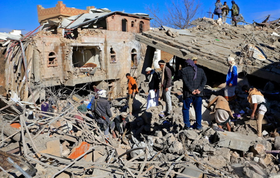 Warga Yaman memeriksa kerusakan menyusul serangan udara semalam oleh koalisi pimpinan Saudi yang menargetkan ibu kota yang dikuasai pemberontak Huthi, Sanaa, pada Selasa 18 Januari 2022.