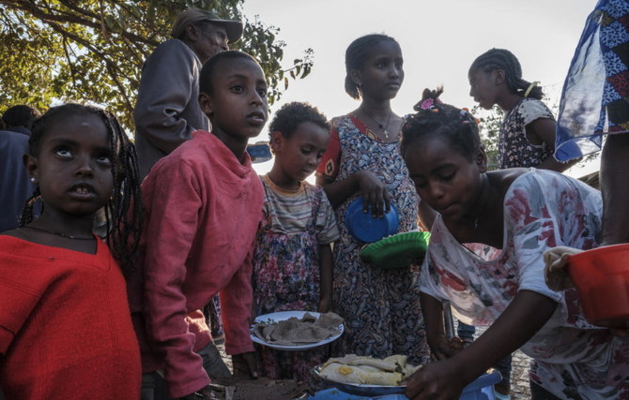 Anak-anak terlantar dari Tigray Barat berkumpul pada waktu makan untuk menerima sepiring makanan di sekolah tempat mereka berlindung di ibu kota Tigray, Mekele, Etiopia.