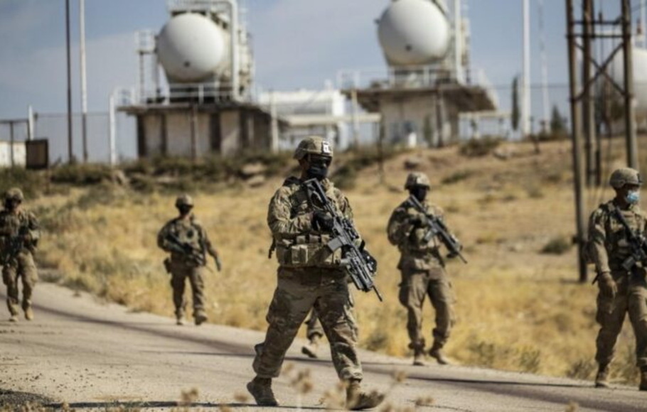 Sejumlah tentara Amerika Serikat berjaga di sekitar ladang minyak di Suriah. 