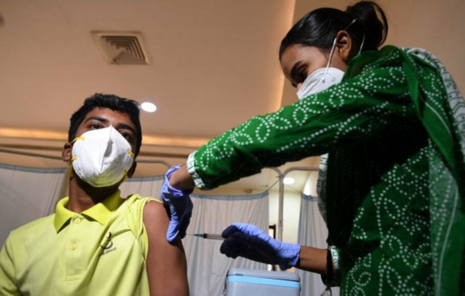 Seorang remaja India menerima vaksinasi Covid-19. 