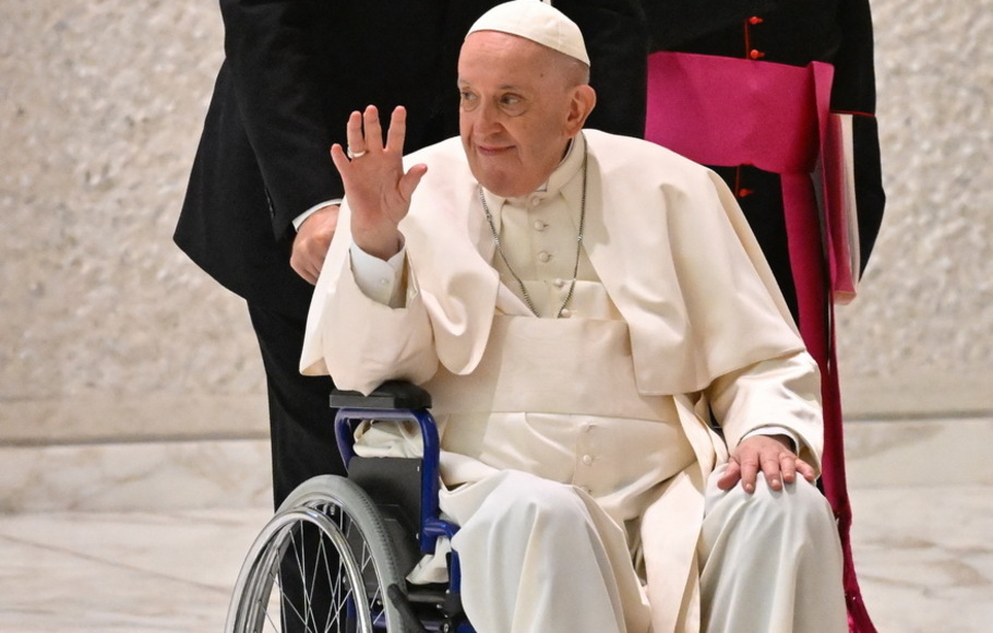 Paus Fransiskus melambaikan tangan saat tiba di kursi roda saat audiensi Peserta Sidang Pleno Persatuan Pemimpin Internasional Internasional di aula Paulus VI di Vatikan, pada Kamis 5 Mei 2022. 