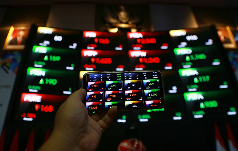 Pengunjung mendokumentasikan pergerakan harga saham di Bursa Efek Indonesia (BEI), di Jakarta.