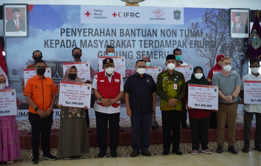 Proses pencairan dana bantuan non tunai (BNT) kepada korban terdampak erupsi Gunung Semeru yang diserahkan PMI dibantu oleh pihak Pos Indonesia.