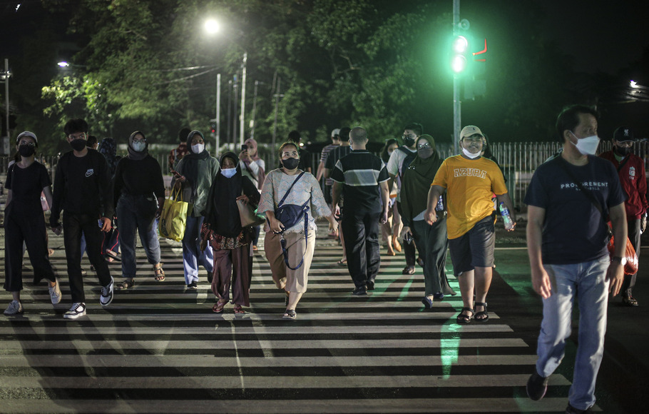 Sejumlah warga melintasi zebra cross di Jalan Jendral Sudirman, Jakarta, Minggu (15/5/2022). Indonesia sudah mulai bertransisi dari pandemi Covid-19 menuju fase endemi.