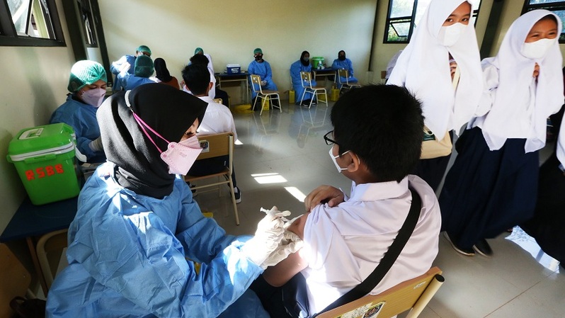 Tenaga kesehatan menyuntikkan vaksin Covid -19 kepada siswa SMP di Gebyar Vaksinasi Pelajar Kota Depok (Ge-SIP) di SMPN 25, Depok, Jawa Barat .  Foto ilustrasi: Beritasatu Photo/Uthan AR