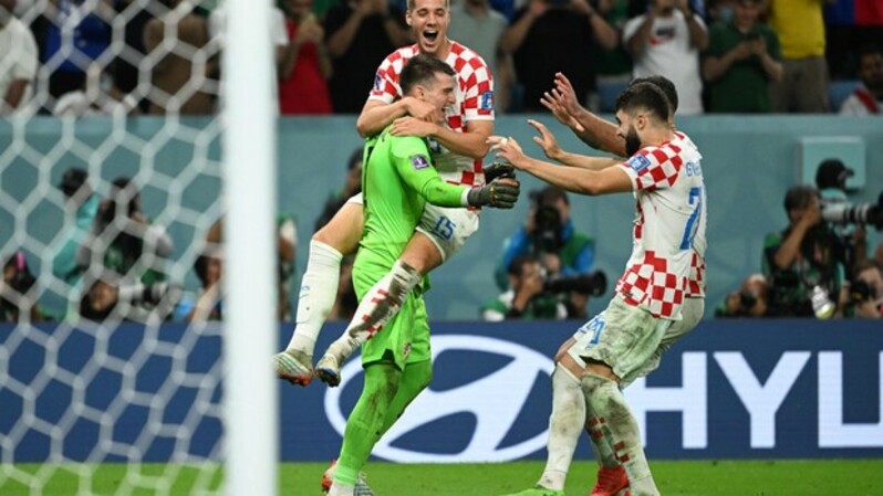 Kiper Kroasia Dominik Livakovic merayakan kemenangan atas Jepang bersama rekan-rekannya.