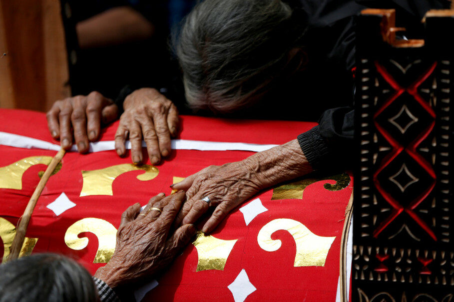 Relatives grieve at the coffin containing the body of an elderly woman, Ne' Ponno, who died more than a year ago, during a funeral ceremony, known as 'Rambu Solo,' in Batu Busa, North Toraja, South Sulawesi, Sept. 13. (Reuters Photo/Darren Whiteside)