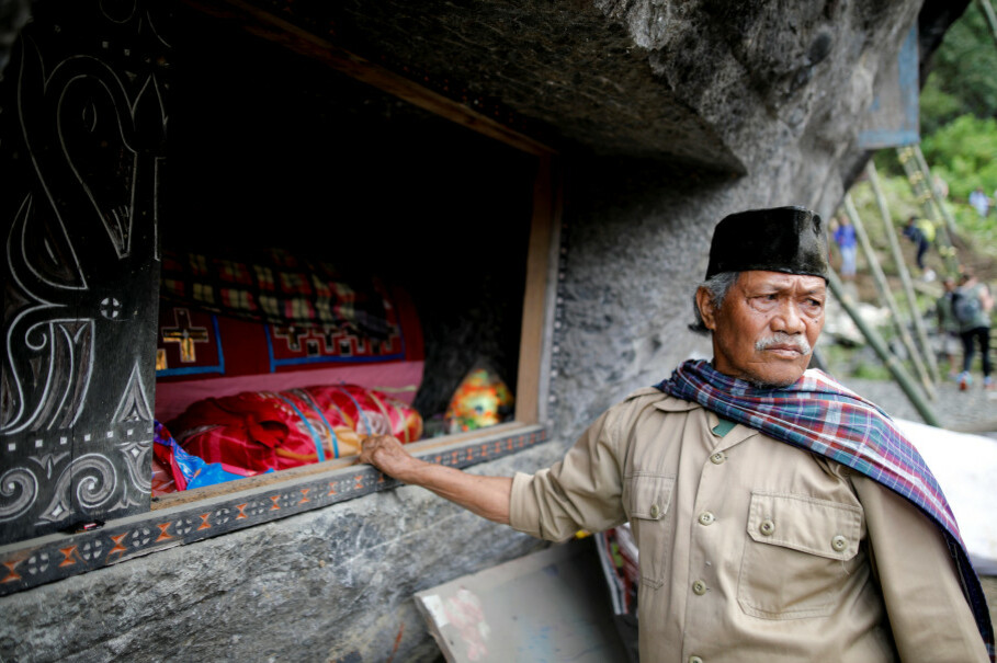 A man stands next to a burial chamber containing the bodies of his relatives. (Reuters Photo/Darren Whiteside)