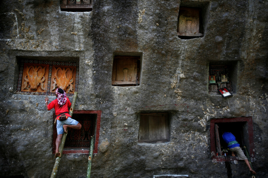 Men use bamboo ladders to open doors to burial chambers. (Reuters Photo/Darren Whiteside)