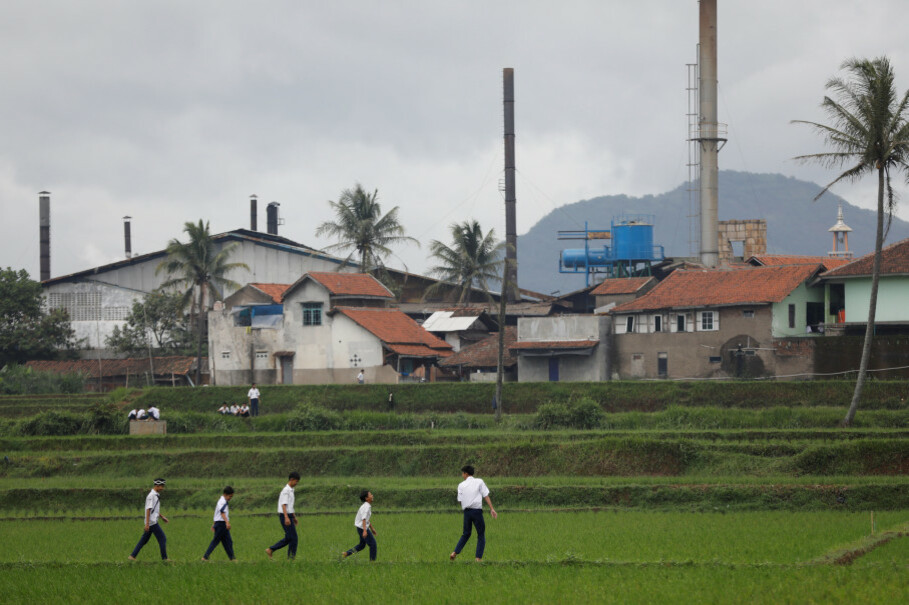 Students walk through rice fields near Majalaya. (Reuters Photo/Darren Whiteside)