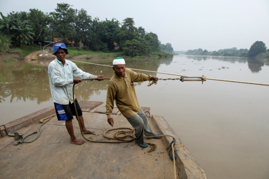 Ferrymen guide a boat across the Citarum River, southeast of Muara Gembong. (Reuters Photo/Darren Whiteside)