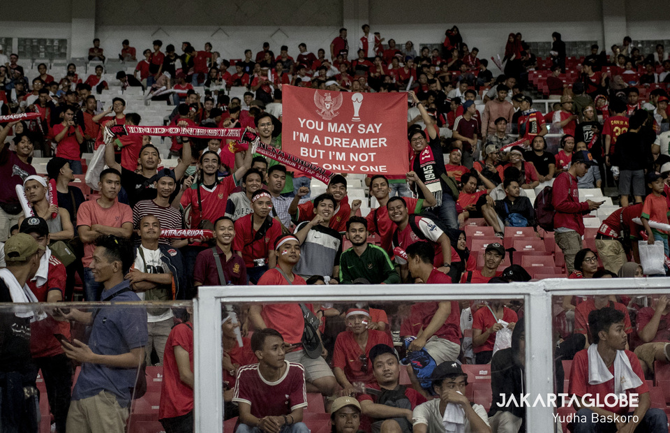 Indonesian supporters hold up a banner with part of the lyrics from the John Lennon song 'Imagine,' at the end of the match. (JG Photo/Yudha Baskoro) 