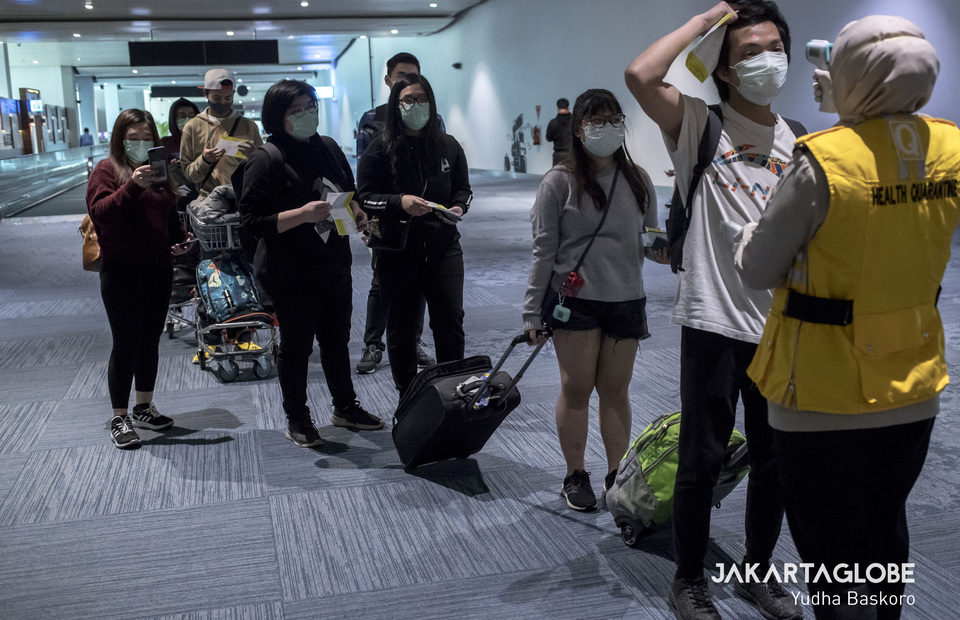 Travellers from China are being inspected at arrival gate in Soekarno-Hatta International Airport. (JG Photo/Yudha Baskoro)