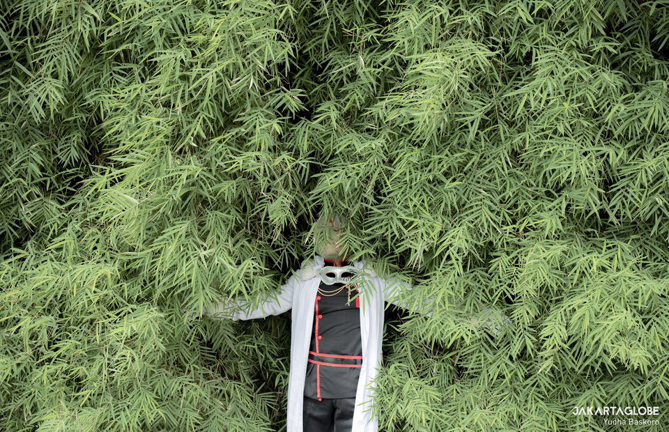 A cosplayer poses behind a bamboo bush on May 29, 2020. .According to Semiarto Purwanto, an anthropologist from the University of Indonesia, during the pandemic the hikikomori phenomenon is seen on the wibu