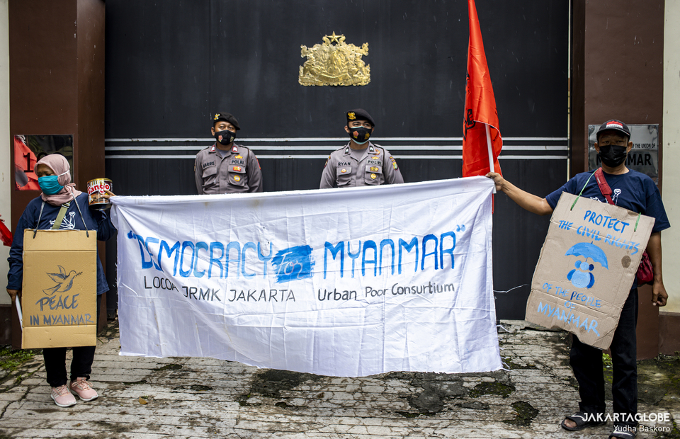 Protesters carry a banner during protest in front of Myanmar Embassy in Central Jakarta on Feb, 5, 2021. (JG Photo/Yudha Baskoro)