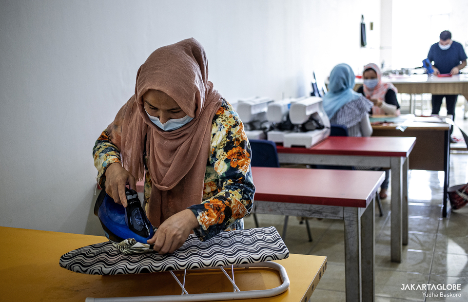 A refugee irons a small bag at Liberty Society workshop in Serpong, South Tangerang on Feb, 3, 2021. (JG Photo/Yudha Baskoro)