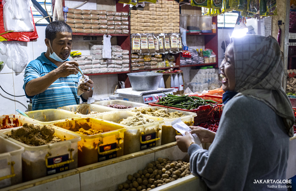 Heri serves his customer at Tebet traditional market in South Jakarta on Feb, 8, 2021. He sells blended spices since 1988. (JG Photo/Yudha Baskoro)