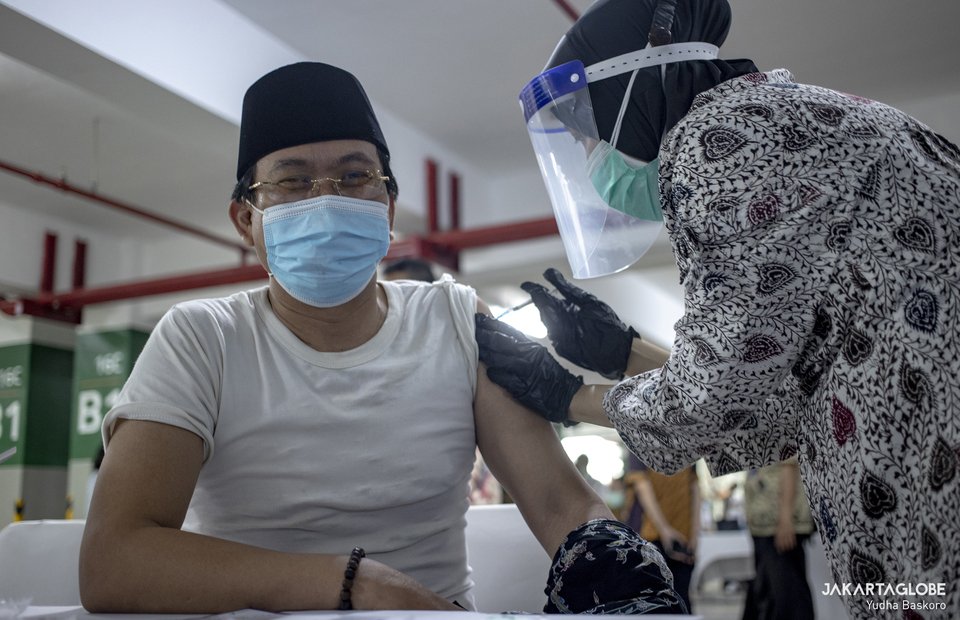 Indonesian muslim cleric gets a jab of Covid-19 vaccine during the first phase of the nationwide Covid-19 vaccine campaign for religious leaders at Istiqlal Mosque in Central Jakarta on Feb 25, 2021. (JG Photo/Yudha Baskoro)