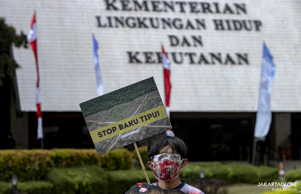 A protester carries poster during protest in front of the Environment and Forestry Ministry (KLHK) building in Central Jakarta on April 8, 2021. (JG Photo/Yudha Baskoro)