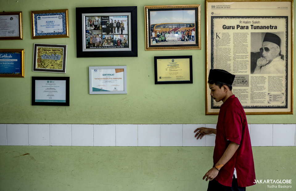 A student touch a wall to find a direction at Raudlatul Makfufin, an Islamic boarding school for the blind and visually challenged in Serpong, South Tangerang, Banten on April 21, 2021. (JG Photo/Yudha Baskoro)