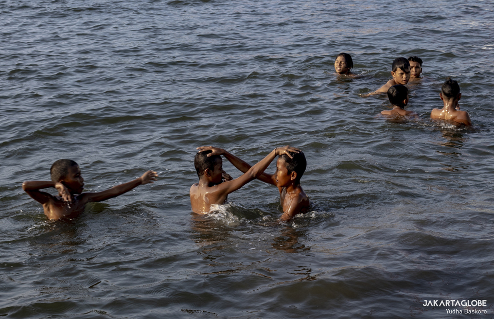 Children swim in Muara Baru, North Jakarta on August 12, 2021. (JG Photo/Yudha Baskoro)