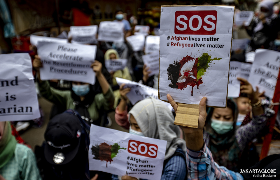 Afghan refugees carries a placard that reads Afghan Lives Matter during protest in front UNHCR building in Central Jakarta on November 15, 2021. (JG Photo/Yudha Baskoro)