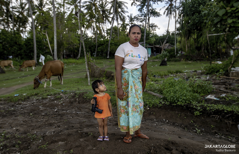 A woman and her daughter stands outside her home at Bunut Hamlet, in the middle of Mandalika Circuit, Central Lombok, West Nusa Tenggara on November 22, 2021. (JG Photo/Yudha Baskoro)