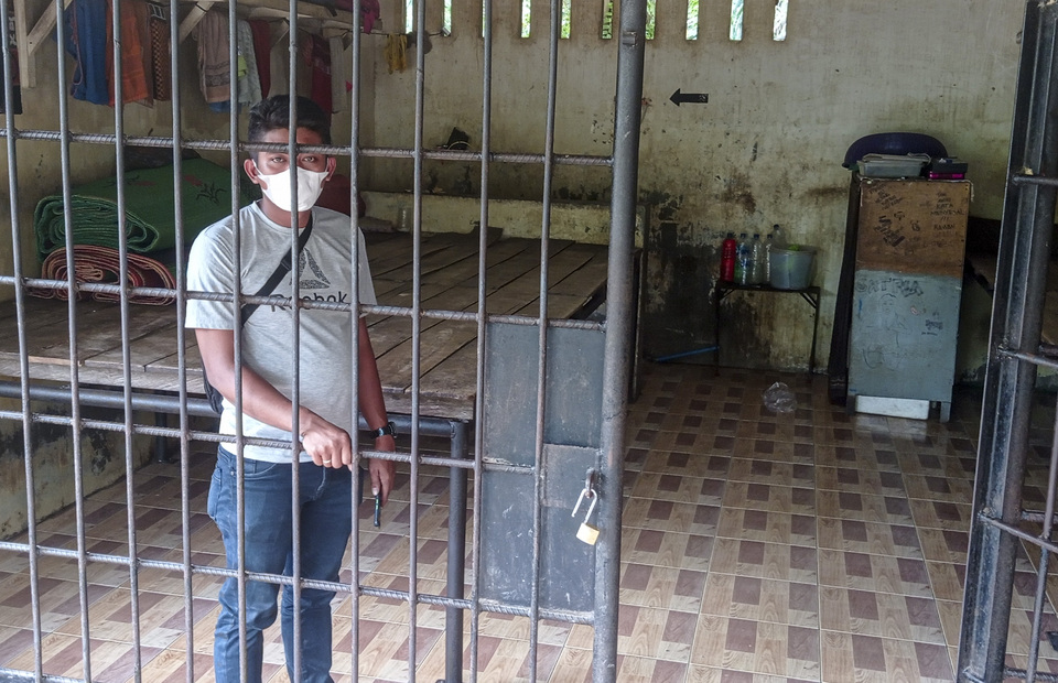 A man stands inside the illegal prison cell found at the residence of Terbit Rencana Perangin Angin, the head of Langkat District in North Sumatra, on January 26, 2022. (Antara Photo)