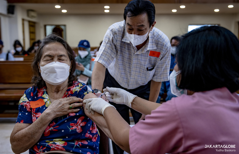 A woman receives her booster dose during a mass Covid-19 vaccination program that is held at a HKBP Menteng church at Central Jakarta on February 3, 2022. (JG Photo/Yudha Baskoro