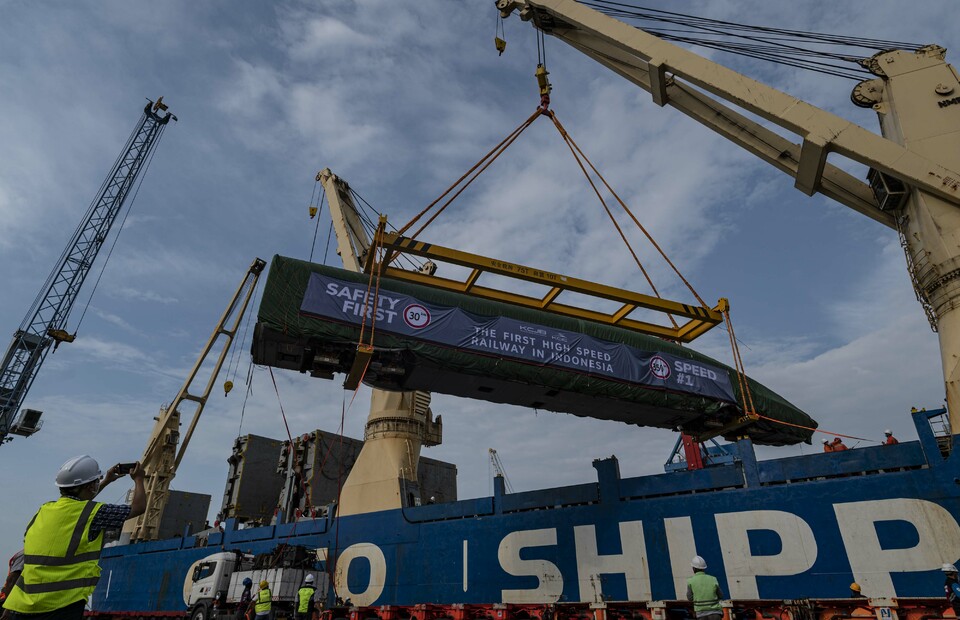 Workers unload a train carriage at Tanjung Priok Port in North Jakarta on Sept. 2, 2022. The train is the first delivery for the Indonesia-China High-Speed Train Project connecting Jakarta and Bandung. (Antara Photo/Aprillio Akbar)