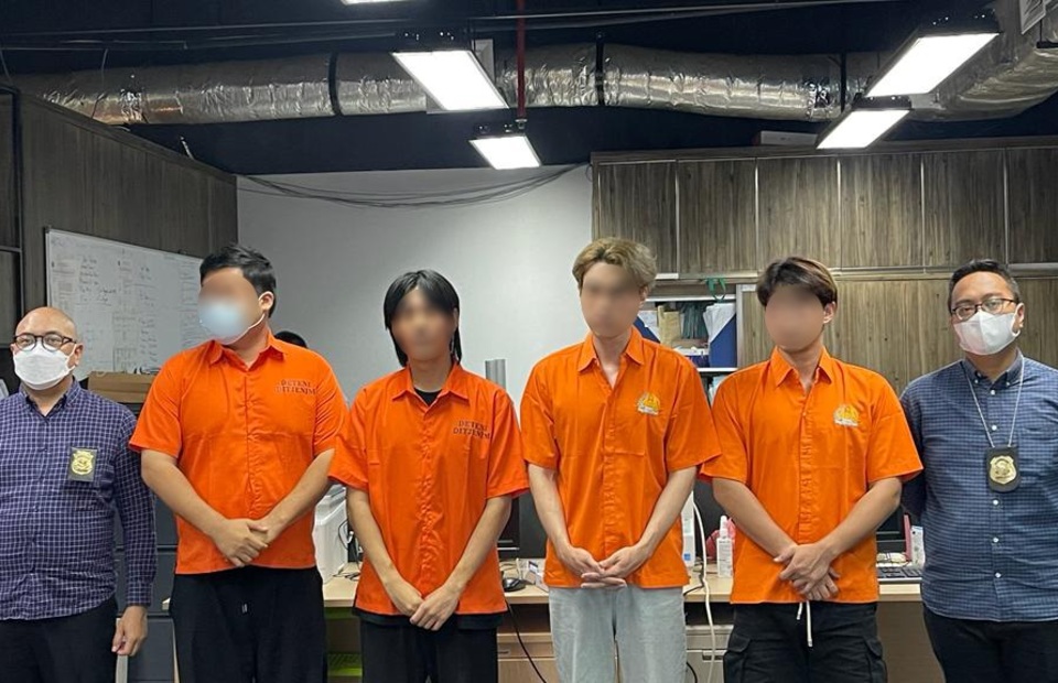 in this undated photo, for South Korean citizens in orange detainee suits are detained for alleged visa violation and fraud. (Photo courtesy of the Immigration Directorate)