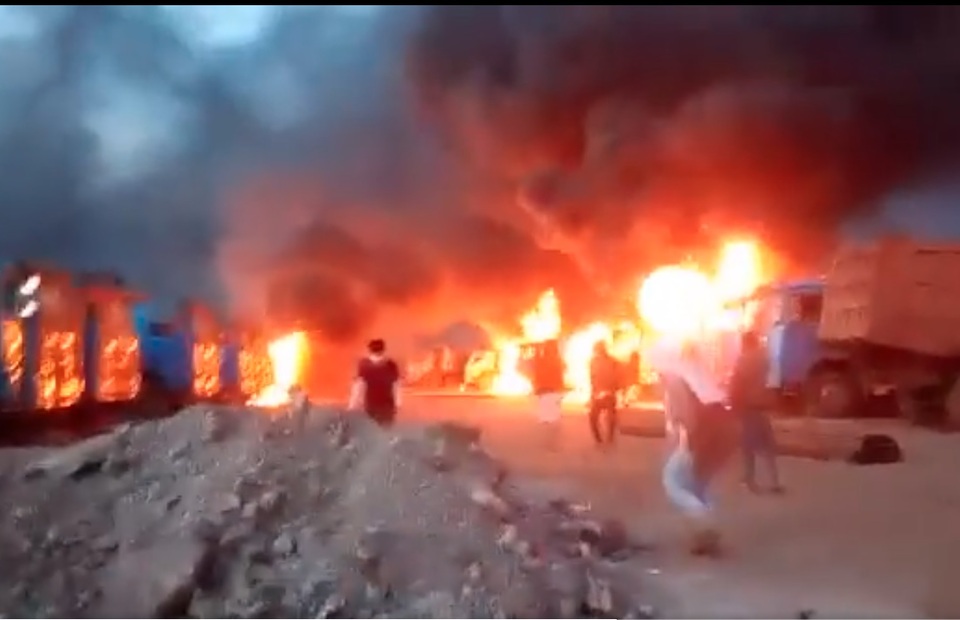 Screen capture of an amateur video shows protesters burning dump trucks belonging to mining company Gunbuster Nickel Industry in North Morowali, Central Sulawesi, on January 14, 2023.