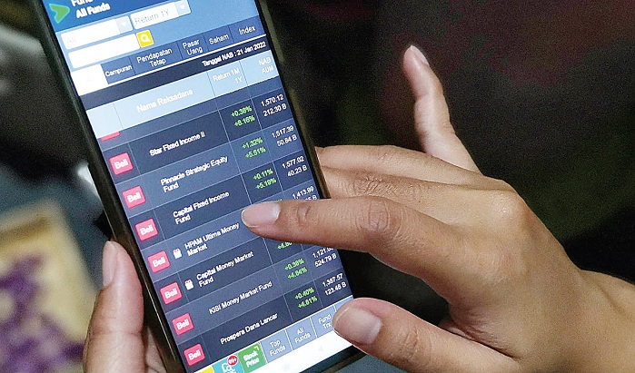 Seorang investor memantau pergerakan saham melalui ponselnya di kawasan Depok. Foto ilustrasi: Investor Daily/David Gita Roza